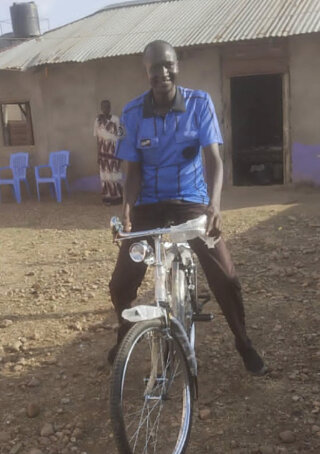 Pastor John Monyjok smiles as he tests his bicycle in Juba Metropolitan Region of South Sudan.