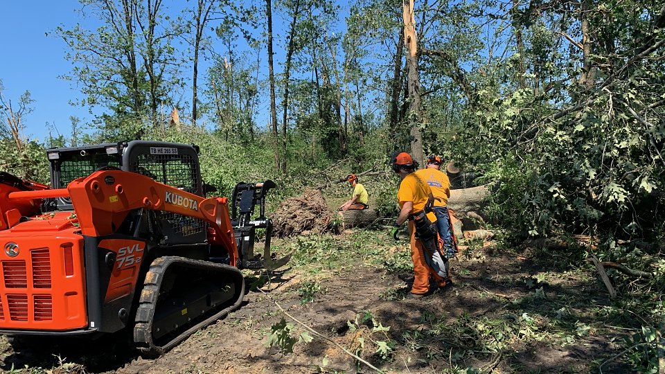 disaster relief teams brought in heavy equipment to remove fallen trees