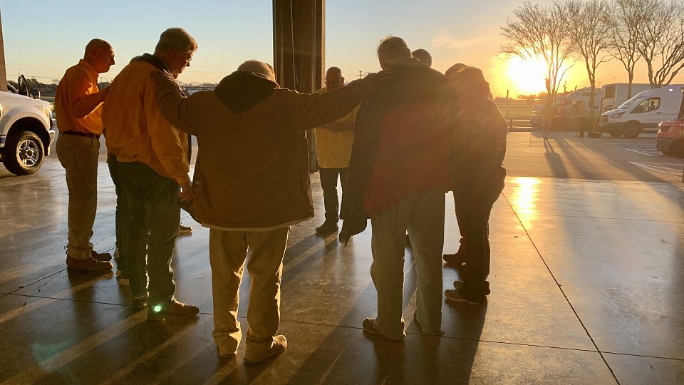 tbm disaster relief volunteers pray before deployment